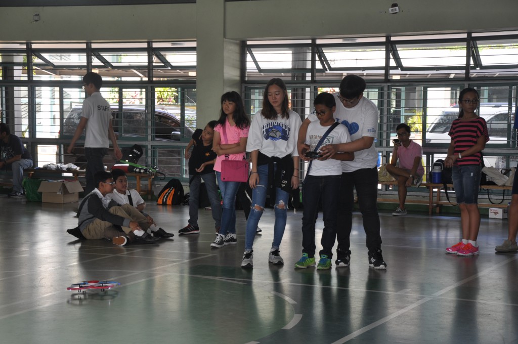 SRHS students teaching one of our very own Robotics Team members how to operate a drone.