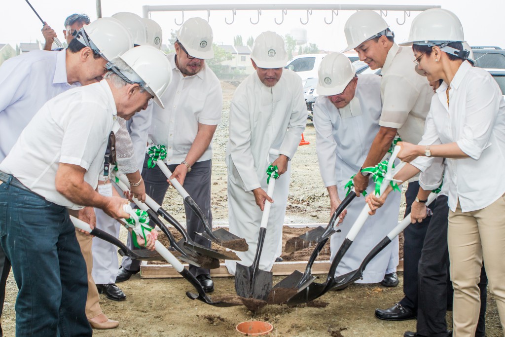 Officials shovel soil over the time capsule, a signal to start the construction of the Vermosa Campus.